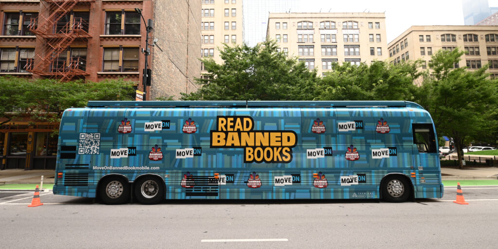 An image of MoveOn's Banned Bookmobile, a blue bus with the words Read Banned Books on the side.
