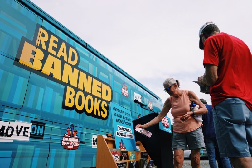 A large blue bus with the phrase, "Read Banned Books." Credit: MoveOn