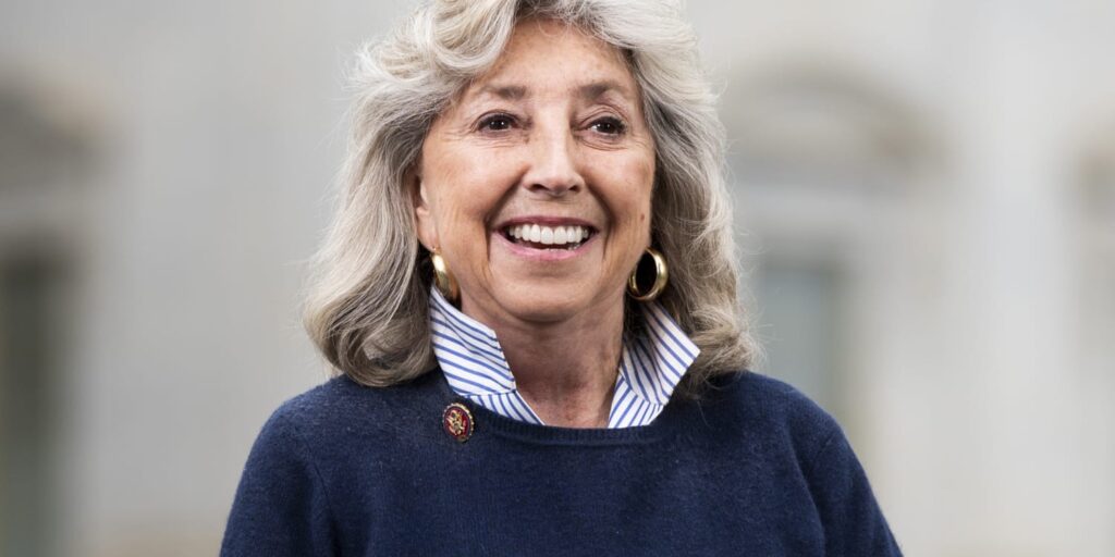 Dina Titus in navy sweater in front of a blurred background.